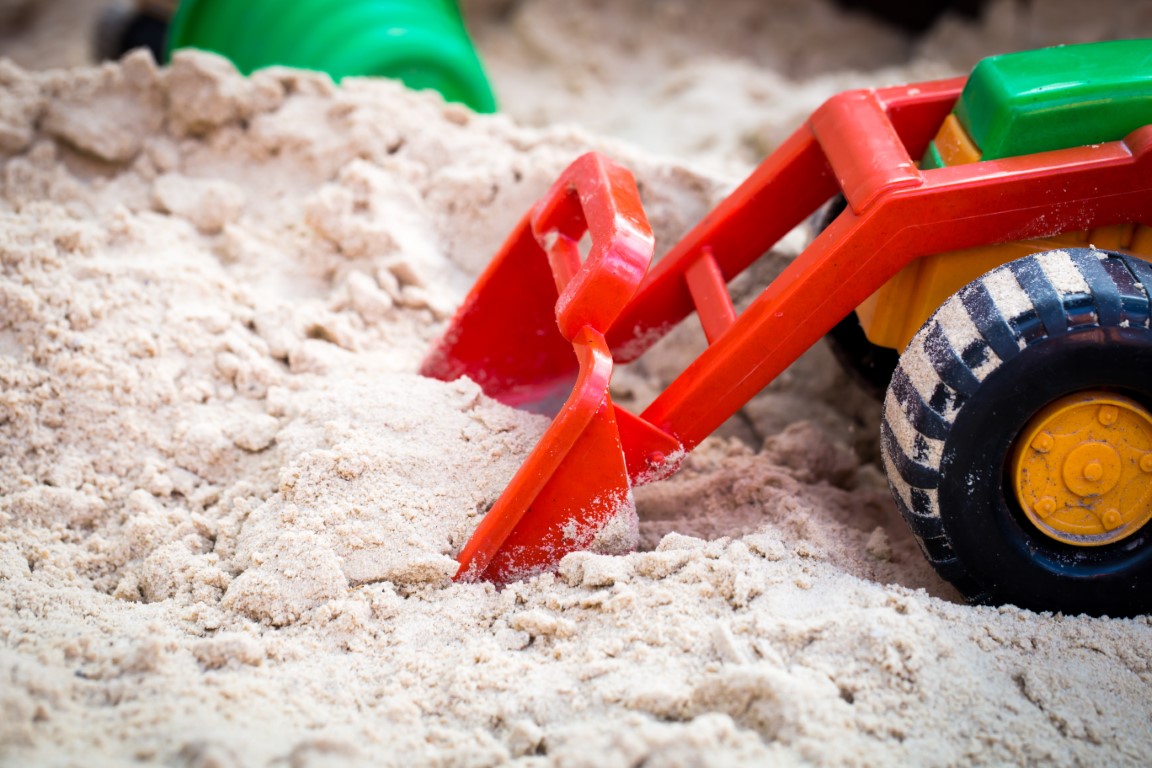 Spielzeugbagger im Sandkasten